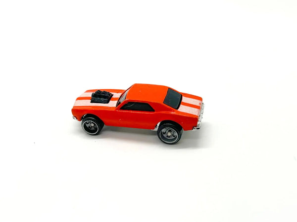 A small red toy muscle car with white racing stripes, a black hood scoop, and black wheels, photographed on a plain white background.
