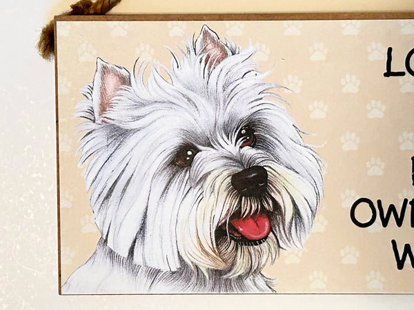 Showcase your love for Westies with this charming, decorative wooden hanging sign. The sign features the heartwarming phrase "Love is... Being Owned by a Westie" and depicts a delightful West Highland White Terrier. 