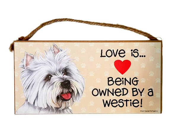 Showcase your love for Westies with this charming, decorative wooden hanging sign. The sign features the heartwarming phrase "Love is... Being Owned by a Westie" and depicts a delightful West Highland White Terrier. 