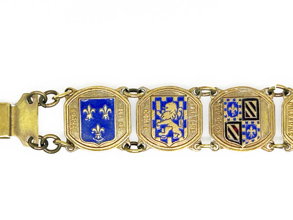 Perfect for vintage jewelry lovers: our Vintage French Souvenir Panel Bracelet provides a stunning display of French heraldic crests. Shop today!