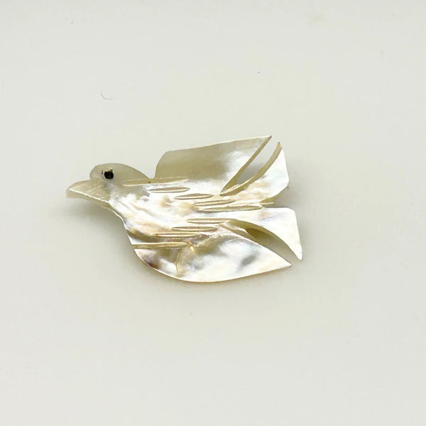 Perfect for vintage jewelry lovers: our Hand Carved Vintage Mother of Pearl Peace Dove Pin- 1960s provides a timeless symbol of peace. Shop today!