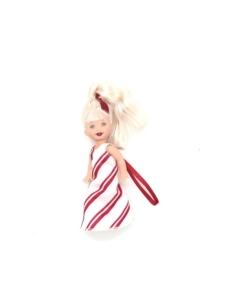 Front view of 2001 Mattel Peppermint Kelly doll from the Kelly Club holiday collection. The miniature doll features blonde hair with red highlights in a high ponytail and a floor-length white gown with diagonal red peppermint stripes