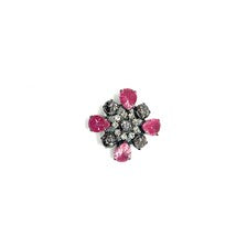Vintage costume jewelry brooch pin featuring a central rhinestone cluster encircled by a halo of clear crystals, with alternating pear-cut pink faux rubies and round faceted gunmetal black stones in a dark metallic prong setting.