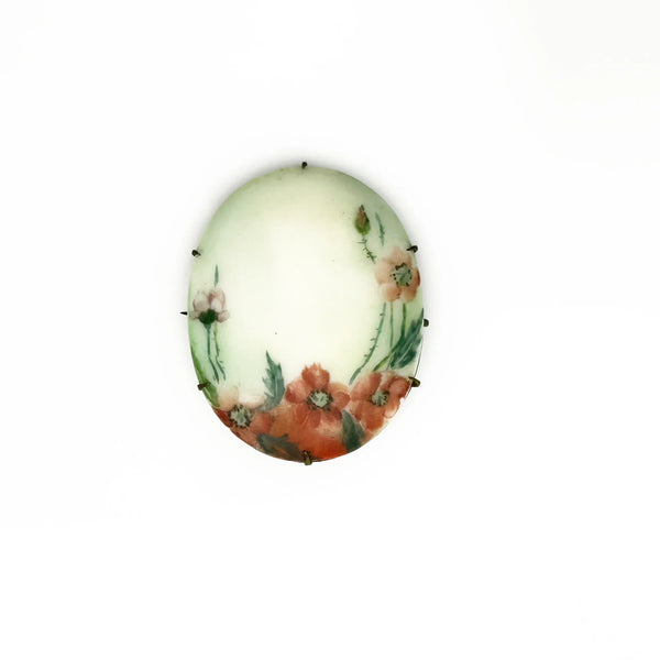 A charming slice of history pinned to your lapel! This delicate porcelain red poppy brooch whispers tales from the Victorian and Edwardian eras, hand-painted with the care artisans devoted to their craft over a century ago.