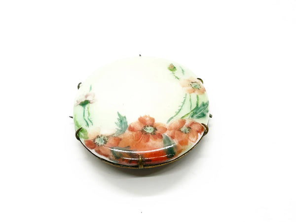 A charming slice of history pinned to your lapel! This delicate porcelain red poppy brooch whispers tales from the Victorian and Edwardian eras, hand-painted with the care artisans devoted to their craft over a century ago.