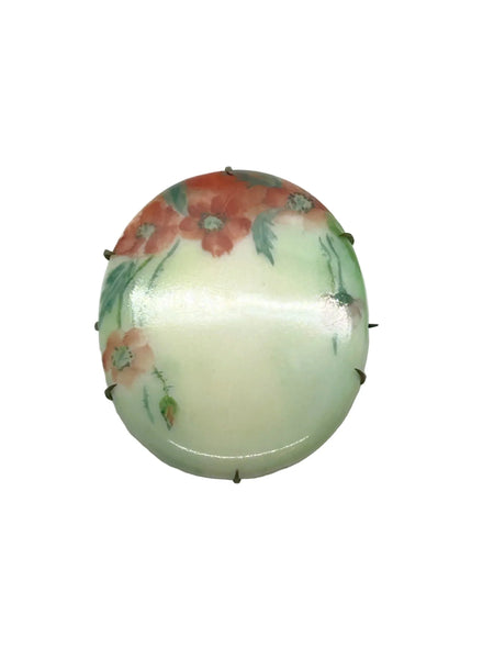 A charming slice of history pinned to your lapel! This delicate porcelain red poppy brooch whispers tales from the Victorian and Edwardian eras, hand-painted with the care artisans devoted to their craft over a century ago.
