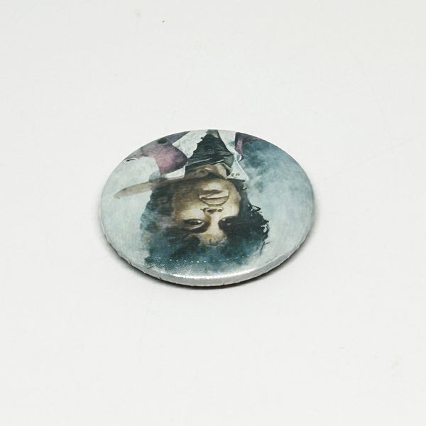 A vintage 1984 Prince pinback button badge featuring a painted portrait of Prince Rogers Nelson during the Purple Rain era