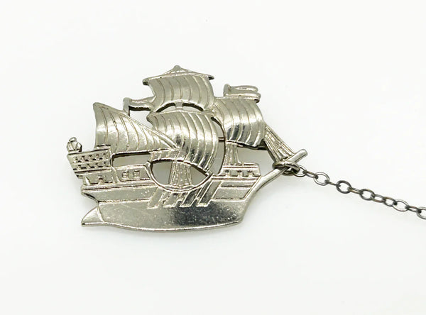 Step back in time with this charming vintage brooch set!! This whimsical dual brooch features a meticulously crafted sailing ship elegantly connected by a gleaming chain to a sturdy anchor. The intricate details and silver-tone finish are truly captivating, making this piece a delightful find for any vintage jewelry enthusiast
