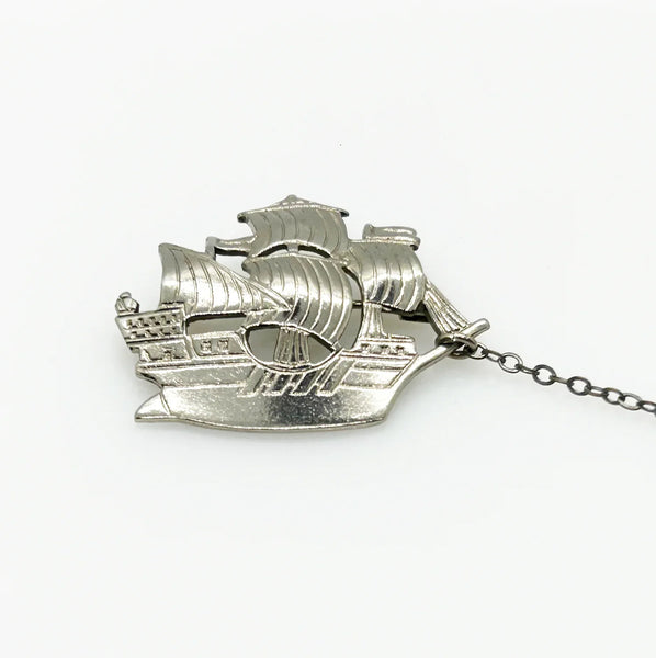 Step back in time with this charming vintage brooch set!! This whimsical dual brooch features a meticulously crafted sailing ship elegantly connected by a gleaming chain to a sturdy anchor. The intricate details and silver-tone finish are truly captivating, making this piece a delightful find for any vintage jewelry enthusiast