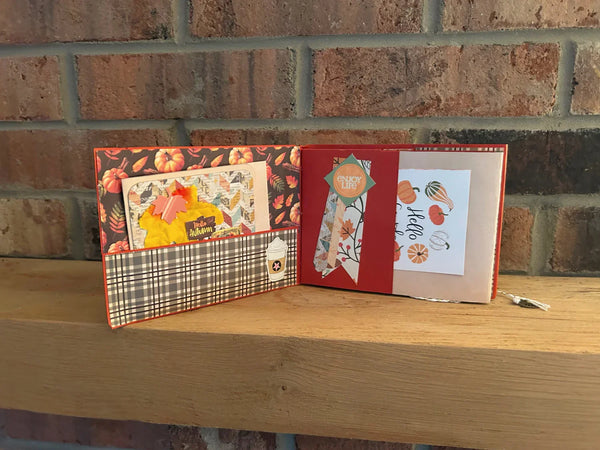 This handmade mini album captures the cozy spirit of autumn. With a warm palette of pumpkin spice, ochre, and wood grain, the album features a tempting cover hinting at a delightful caffeinated beverage. 
