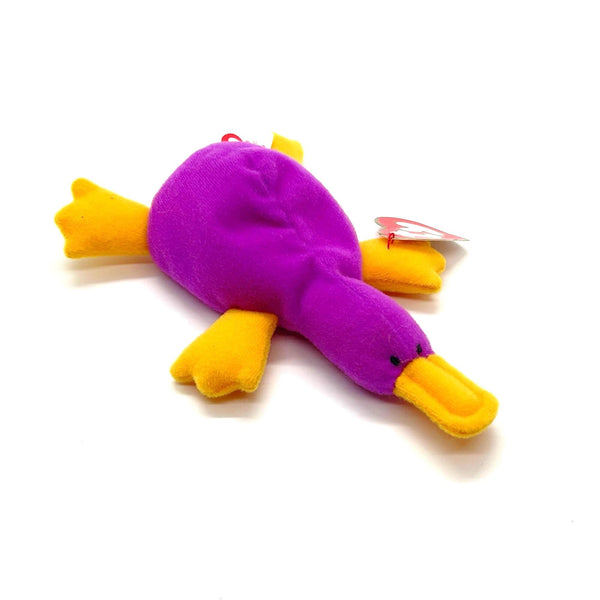 Purple and yellow toy platypus on a white background