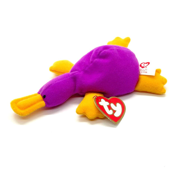 Purple and yellow plush toy with a Ty tag on a white background