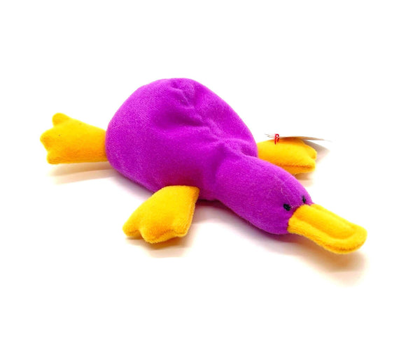 Purple and yellow plush toy on a white background