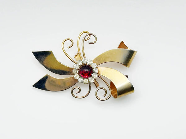 Perfect for vintage jewelry lovers: our Vintage Abstract Bow Brooch with Red Cabochon and Bright Rhinestones provides a unique, bold style boost. Shop today!