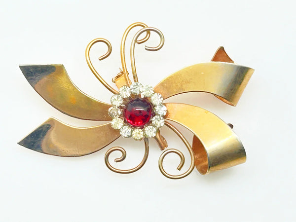 Perfect for vintage jewelry lovers: our Vintage Abstract Bow Brooch with Red Cabochon and Bright Rhinestones provides a unique, bold style boost. Shop today!