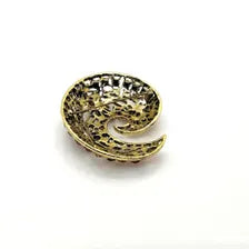 Close-up detail of a mid-century paisley swirl pin showing the openwork metal vines and prong-set pink and red rhinestone crystals