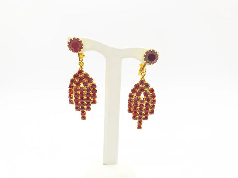 Bright red sparkling round rhinestones glitter in a gold tone setting. They give Art Deco vibes while being easy to wear and fun. They each measures 2" long and are in near mint condition, with hinge backs.