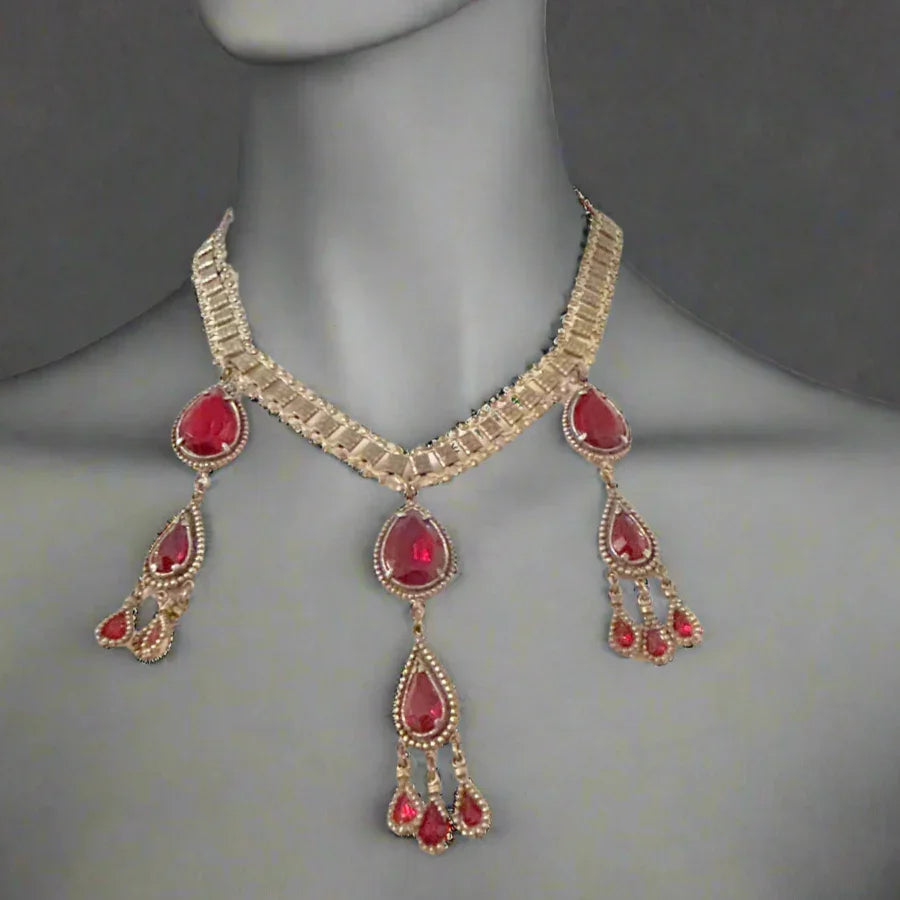 Experience breathtaking beauty with our exclusive Ornate Vintage Drop Necklace. Radiant red teardrop stones set in three long cascading drops, topped with two more tiers of red teardrops, create an eye-catching sparkle that will leave everyone awestruck. 