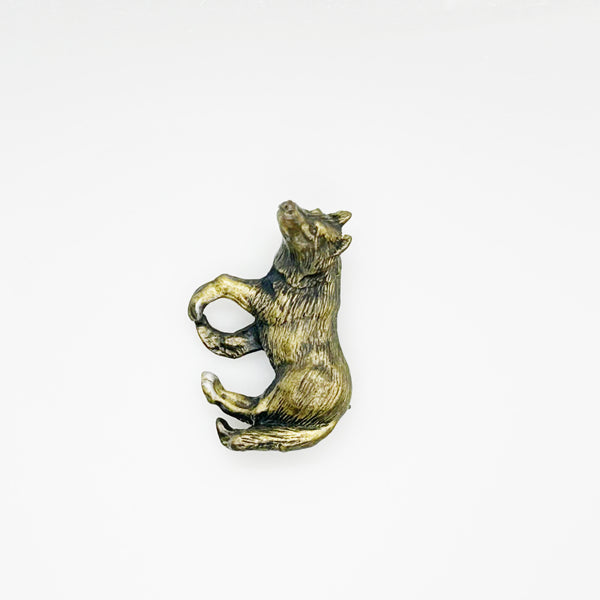vintage bronze wolf brooch pin with highly detailed textured fur on a plain white background