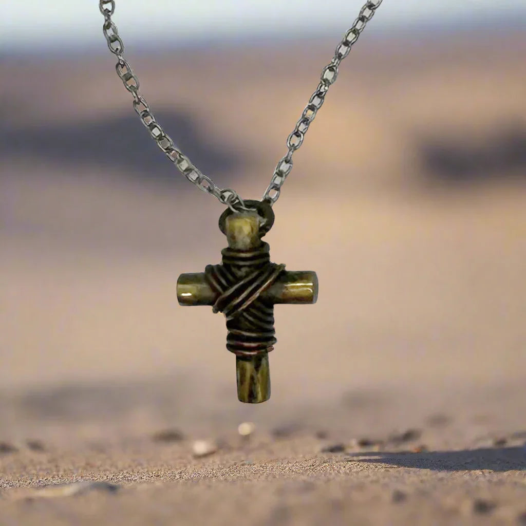 Experience the feeling of strength from the Vintage Rugged Brass Cross Necklace, exuding a bold, rugged aesthetic. With a simple yet substantial design, this pendant features dark metal strands encircling its center. Standing at 1.5" tall, it comes complete with a 24" silvery chain, perfectly complementing its powerful presence. A striking and symbolic piece of faith for the sophisticated individual.&nbsp;