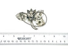 Vintage Silver-Tone Floral Brooch with Blue Rhinestone Center and Textured Leaves