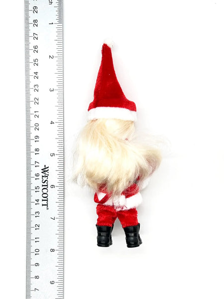 The 2003 Mattel Barbie Kelly Club Santa Claus ornament doll (Model #B1347) is a 4 to 5-inch collectible fashion doll featuring blonde hair and blue eyes.