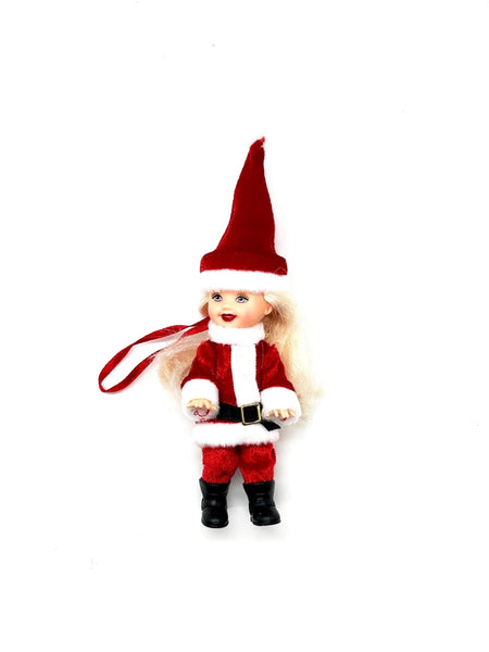 TThe 2003 Mattel Barbie Kelly Club Santa Claus ornament doll (Model #B1347) is a 4 to 5-inch collectible fashion doll featuring&nbsp;Barbie's younger sister, Kelly, dressed in a red and white Santa-inspired outfit, complete with a long red hat, black boots, and a black belt.