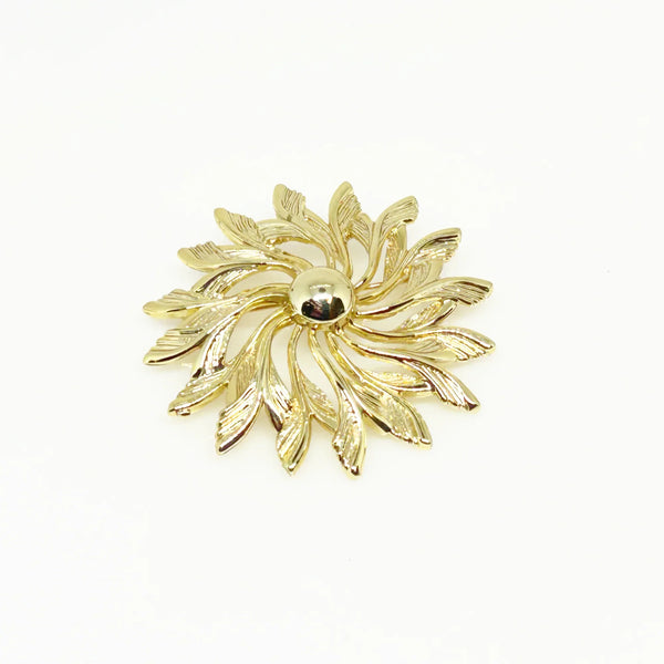 Celebrate timeless elegance with this Sarah Coventry Gold Tone Sunburst Flower Brooch. Featuring a beautifully textured gold-tone design, this vintage piece captures the radiant energy of a blossoming flower or a glowing sunburst.