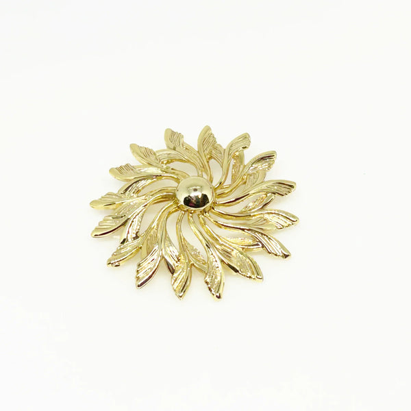 Celebrate timeless elegance with this Sarah Coventry Gold Tone Sunburst Flower Brooch. Featuring a beautifully textured gold-tone design, this vintage piece captures the radiant energy of a blossoming flower or a glowing sunburst.