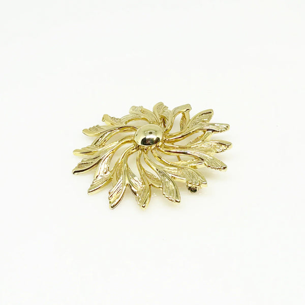 Celebrate timeless elegance with this Sarah Coventry Gold Tone Sunburst Flower Brooch. Featuring a beautifully textured gold-tone design, this vintage piece captures the radiant energy of a blossoming flower or a glowing sunburst.