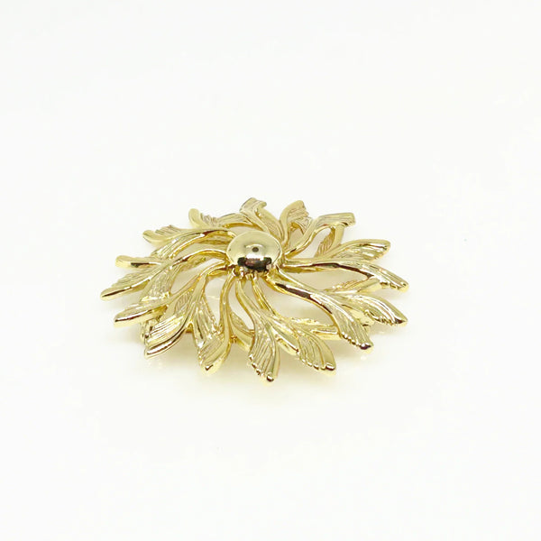Celebrate timeless elegance with this Sarah Coventry Gold Tone Sunburst Flower Brooch. Featuring a beautifully textured gold-tone design, this vintage piece captures the radiant energy of a blossoming flower or a glowing sunburst.