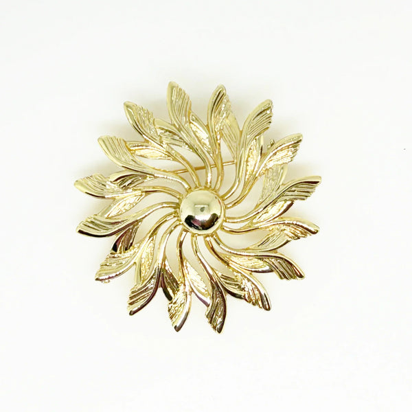 Celebrate timeless elegance with this Sarah Coventry Gold Tone Sunburst Flower Brooch. Featuring a beautifully textured gold-tone design, this vintage piece captures the radiant energy of a blossoming flower or a glowing sunburst.
