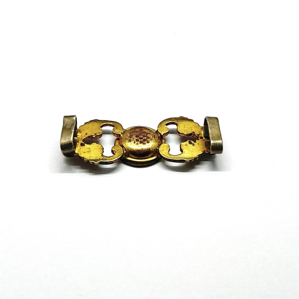 Antique Victorian monogrammed watch slide in gold-tone metal. Features a round hand-engraved monogram center and highly detailed repoussé scrollwork side accents, perfect as a jewelry making component