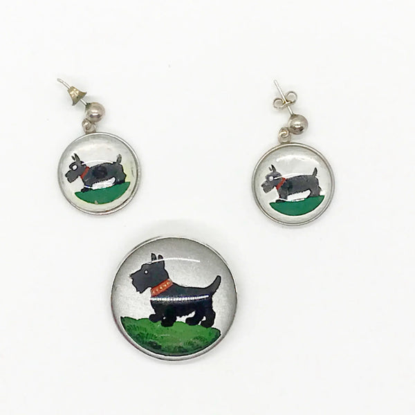 This delightful sterling silver set features an adorable black Scottie dog that's ready to prance right into your jewelry collection! The charming brooch pin (1 1/8" x 1 1/8") adds a playful pop to any dress, sweater, blouse, or scarf, while the matching pierced post earrings (approximately 1 3/4" long) complete the look with tail-wagging style.