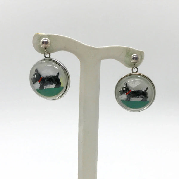 This delightful sterling silver set features an adorable black Scottie dog that's ready to prance right into your jewelry collection! The charming brooch pin (1 1/8" x 1 1/8") adds a playful pop to any dress, sweater, blouse, or scarf, while the matching pierced post earrings (approximately 1 3/4" long) complete the look with tail-wagging style.