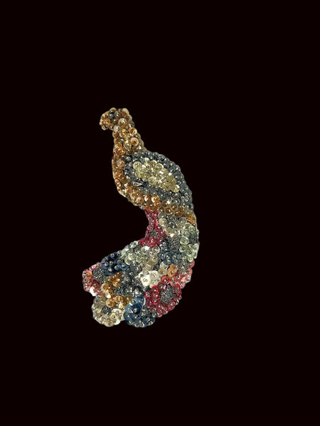 This stunning large peacock brooch showcases an exquisite array of multi-colored sequins in vibrant shades of blue, red, gold, pink, and more, capturing the eye with its lively palette. Meticulously handmade on a sturdy black felt backing, it highlights exceptional craftsmanship and attention to detail. Measuring an impressive 5.25 inches long, this brooch offers a bold statement piece that can elevate any outfit