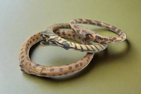 Set of Three Carved Wooden Giraffe Bangle Bracelets,Unleash your wild side with our Set of Three Carved Wooden Giraffe Bangle Bracelets. Each bangle is carefully crafted with a giraffe's face carved into the side, mimicking the animal's iconic markings. The dyed spots add a touch of authenticity to these striking pieces.