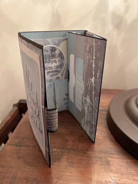 Celebrate determination and achievement with the She Believed Mini Album, a beautifully handcrafted journal that inspires and motivates. This carefully designed keepsake features intricate details, multiple slots, and inserts to hold cherished memories, including two additional mini journals tucked inside