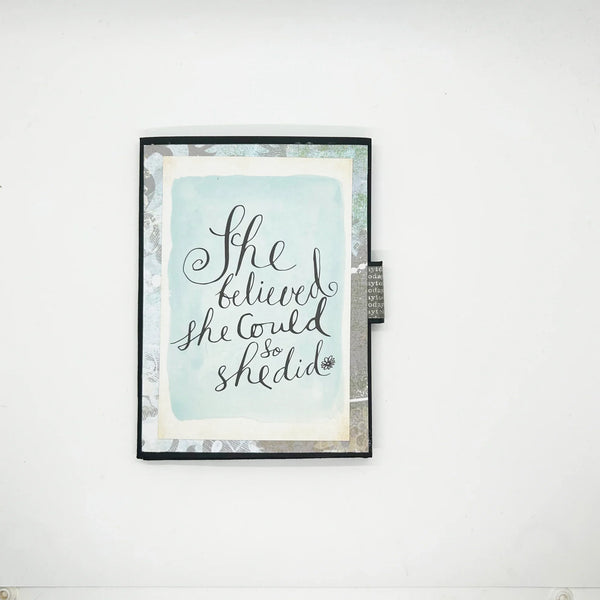 Celebrate determination and achievement with the She Believed Mini Album, a beautifully handcrafted journal that inspires and motivates. This carefully designed keepsake features intricate details, multiple slots, and inserts to hold cherished memories, including two additional mini journals tucked inside