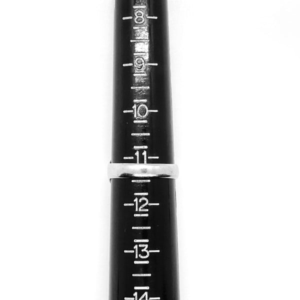 A close-up of a black ring sizer tool with white printed size markings from 8 to 14 and a silver metal band in the center.