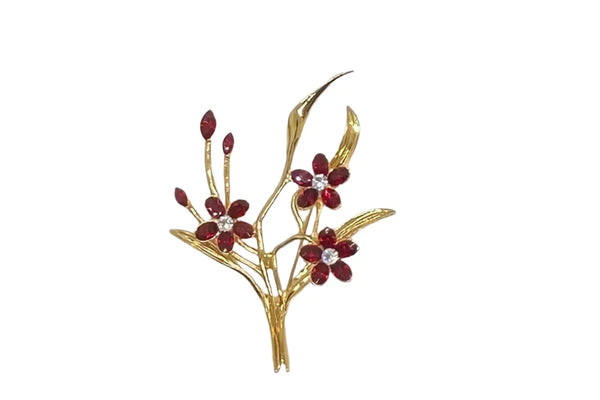 This vintage floral pin will add glamour- three blooms are exquisitely crafted of deep red marquise stones, complemented by a glistening clear rhinestone in the center. This gorgeous piece is in excellent condition and measures 3.25" tall.