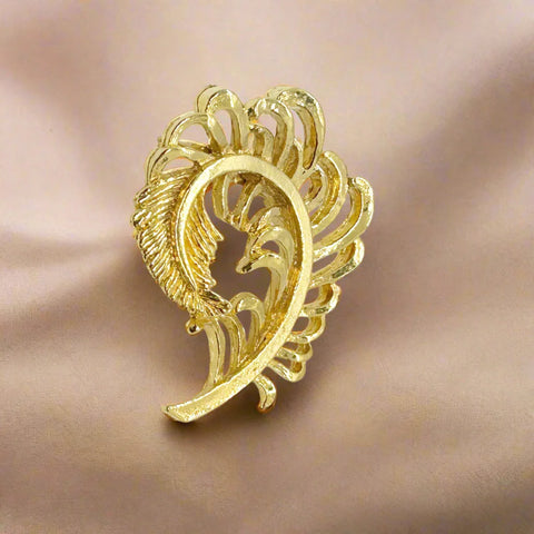 Add some vintage charm to your style with Gerry's Vintage Amusing Gold Feather Plume Brooch. The intricate openwork loops and detailed plume end make it a unique and eye-catching piece. Measuring 2" tall and 1.5" wide, it is the perfect size for any outfit.