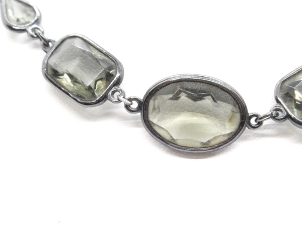 This stunning 1980s necklace features a sophisticated mix of oval, rectangular, and marquise-cut smoky glass stones, each expertly bezel-set into a blackened metal chain.