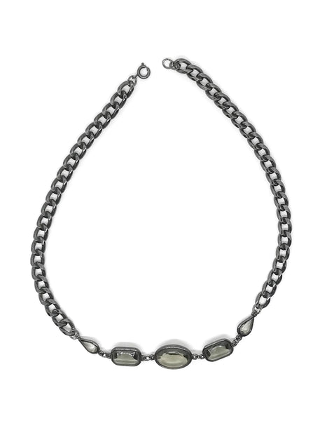 This stunning 1980s necklace features a sophisticated mix of oval, rectangular, and marquise-cut smoky glass stones, each expertly bezel-set into a blackened metal chain.