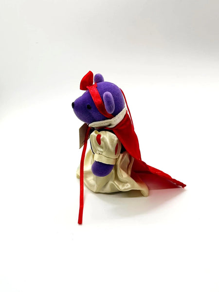 A small, purple plush bear ornament dressed as Snow White. 