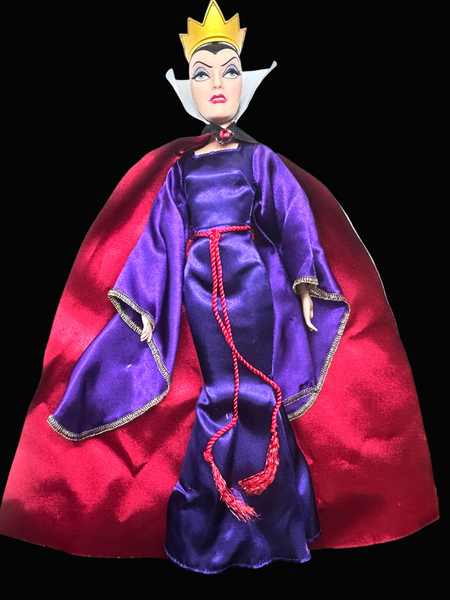 A vintage-style Evil Queen doll with a gold crown, purple gown, and red cape, photographed against a plain white background.