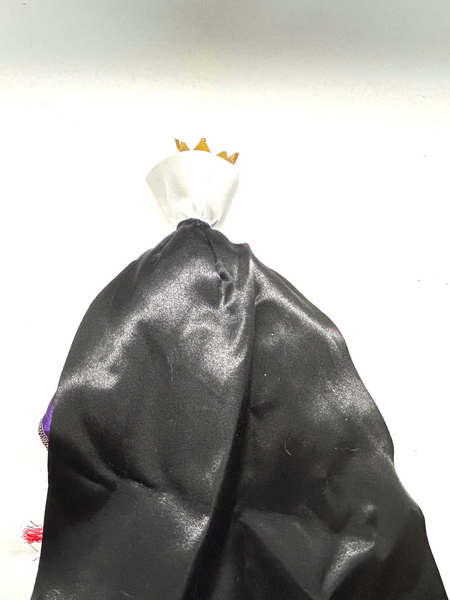 A vintage-style Evil Queen doll with a gold crown, purple gown, and red cape, photographed against a plain white background.