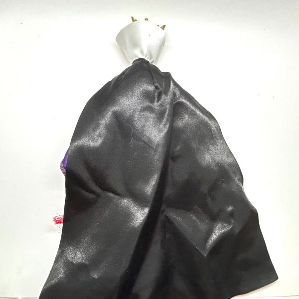 A vintage-style Evil Queen doll with a gold crown, purple gown, and red cape, photographed against a plain white background.