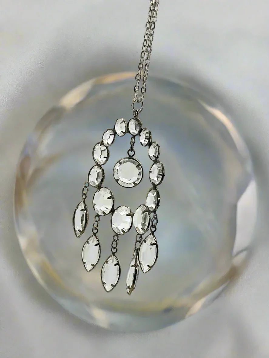 Indulge in the timeless beauty of our estate Art Deco Circle Crystal Pendant. Inspired by the opulence and glamour of the Art Deco era, this exquisite piece showcases an impressive open back design. 