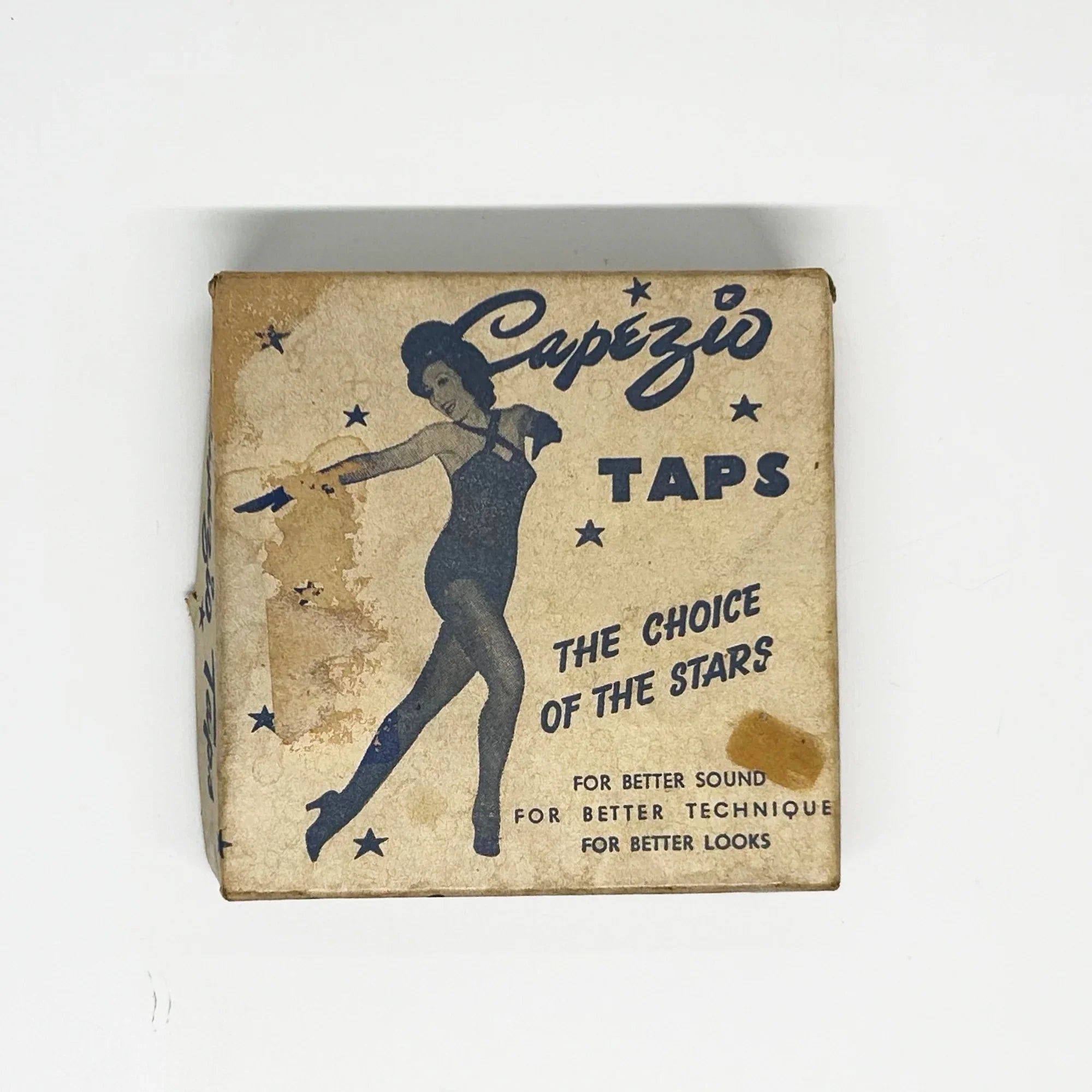Vintage-style box for Capezio taps with a dancer illustration and text on a white background